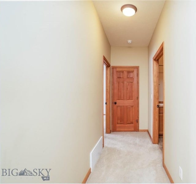 hallway with light colored carpet