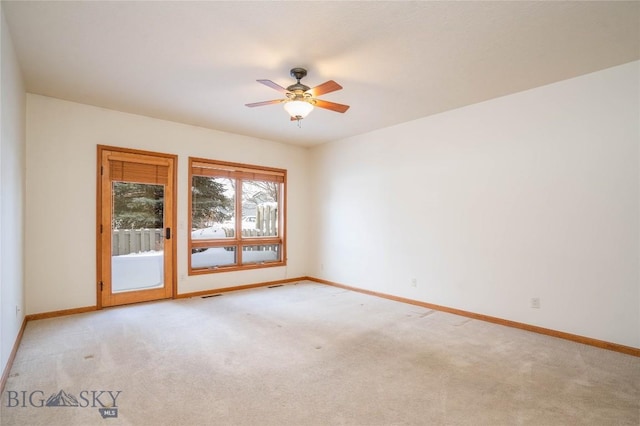 carpeted spare room with ceiling fan