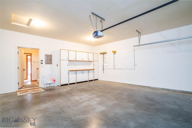 garage featuring a garage door opener and electric panel