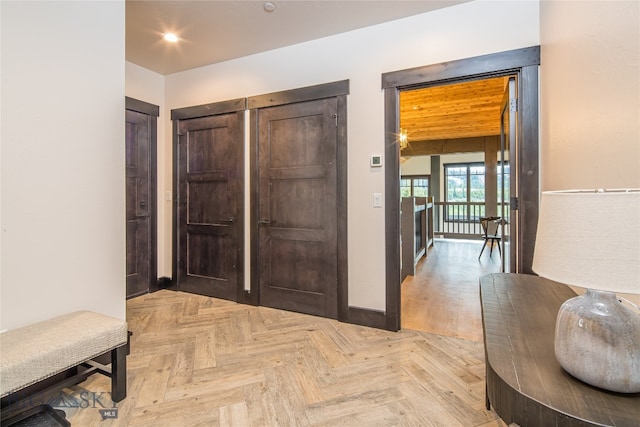 hallway with beamed ceiling and light parquet floors