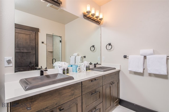 bathroom with vanity and a shower with door