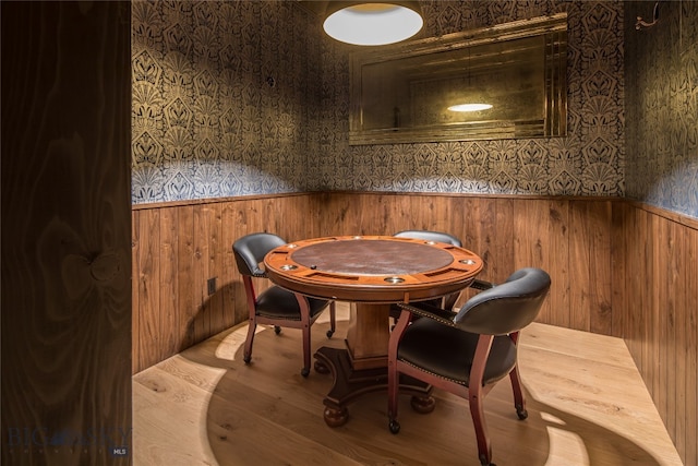 dining room with wooden walls and wood-type flooring