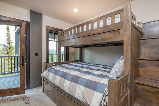 bedroom featuring carpet floors, access to outside, and multiple windows