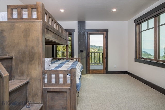 carpeted bedroom featuring multiple windows