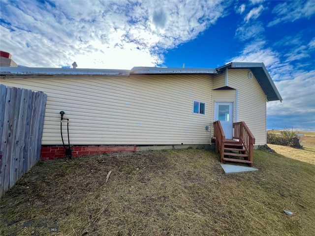 rear view of house featuring a yard