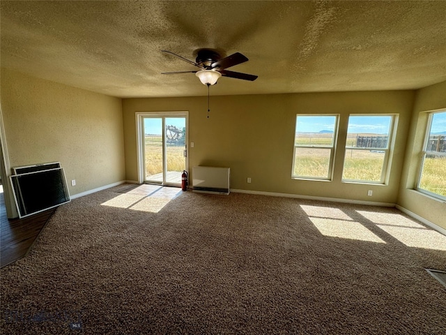 unfurnished room featuring ceiling fan, a textured ceiling, and carpet flooring