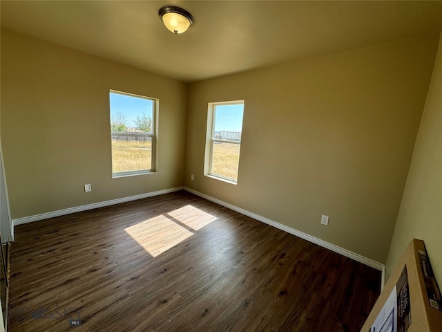 spare room featuring dark hardwood / wood-style flooring