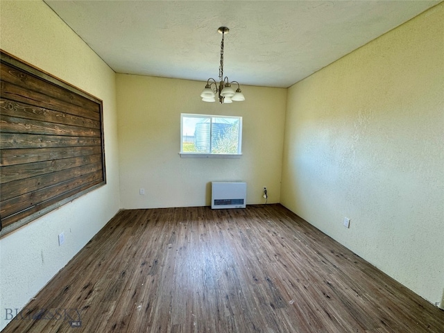 unfurnished dining area featuring dark hardwood / wood-style flooring and a chandelier