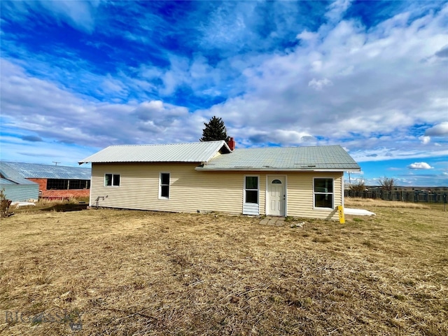 rear view of house with a yard