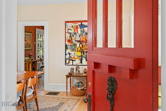 entryway with wood-type flooring