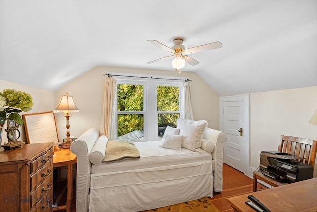 bedroom featuring hardwood / wood-style floors, ceiling fan, and lofted ceiling