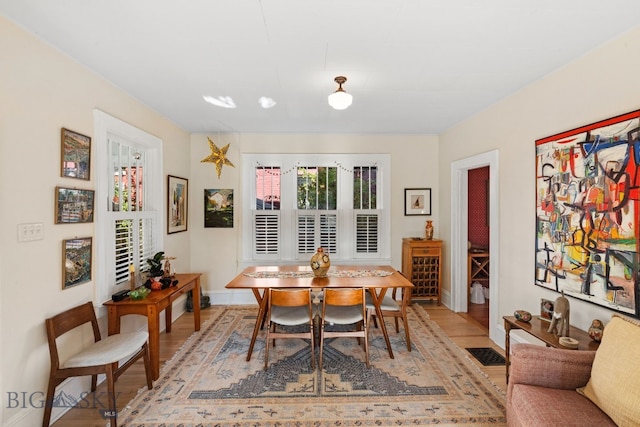 dining space featuring wood-type flooring