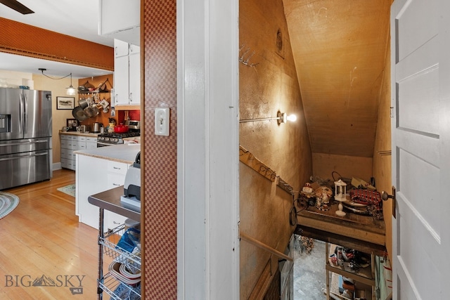 interior space featuring vaulted ceiling and hardwood / wood-style flooring