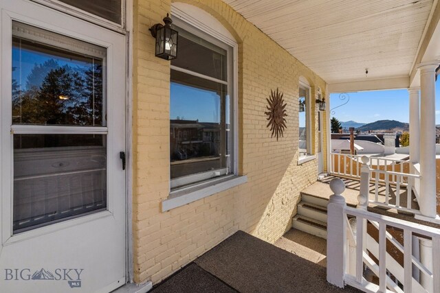 exterior space featuring covered porch and a mountain view