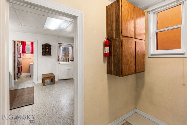 hallway featuring a drop ceiling