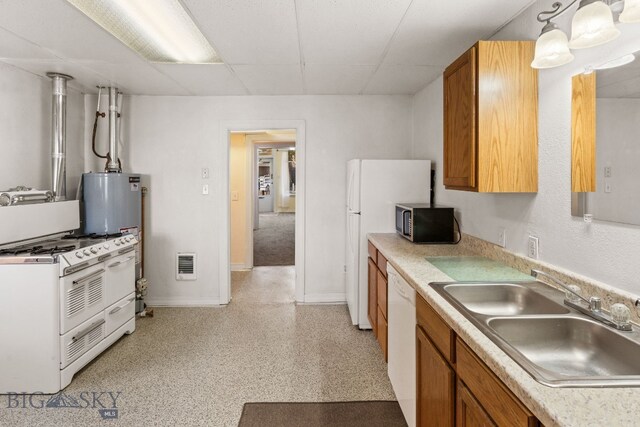 kitchen featuring a paneled ceiling, sink, pendant lighting, gas water heater, and white appliances