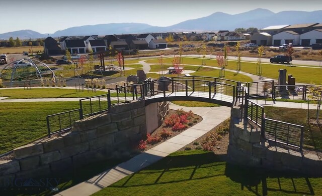 view of home's community featuring a lawn and a mountain view