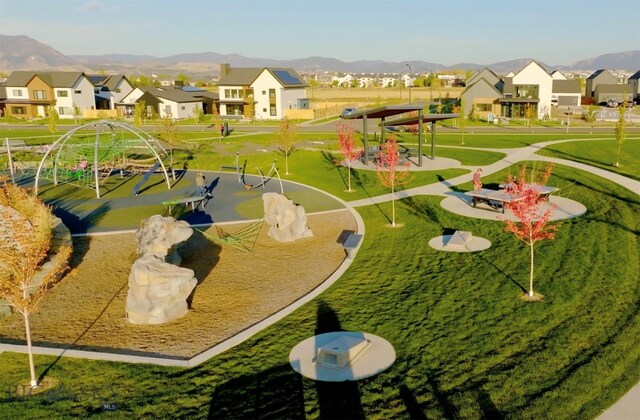 view of property's community with a yard and a mountain view