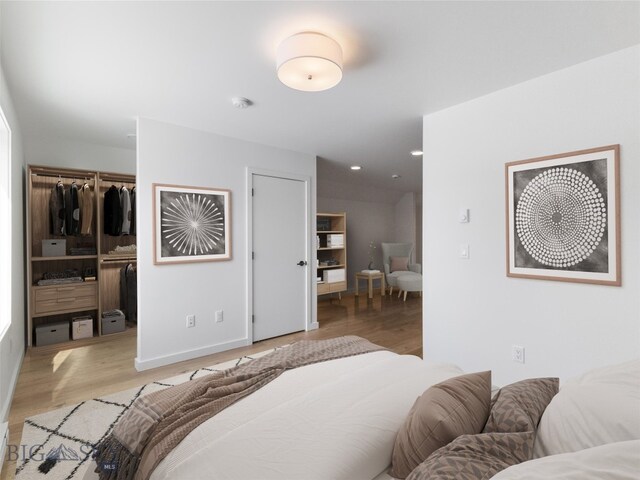 bedroom with a closet and light hardwood / wood-style floors