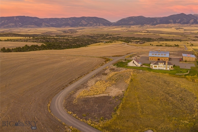 aerial view at dusk featuring a mountain view