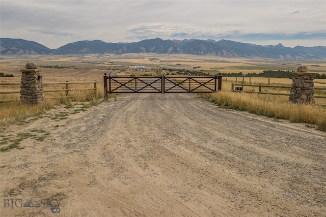 view of gate featuring a mountain view and a rural view