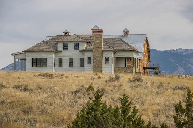 back of house with a mountain view