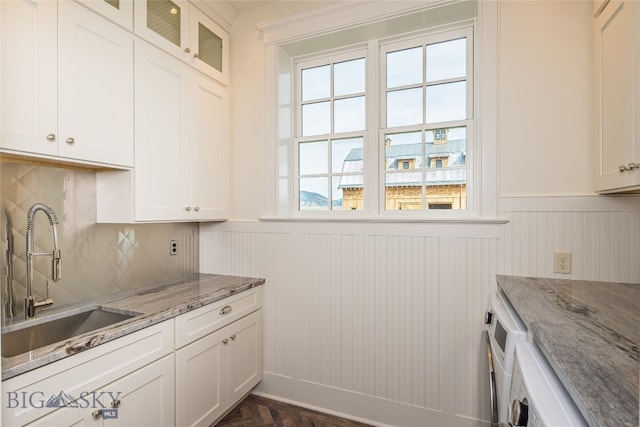 kitchen with white cabinetry, plenty of natural light, and sink