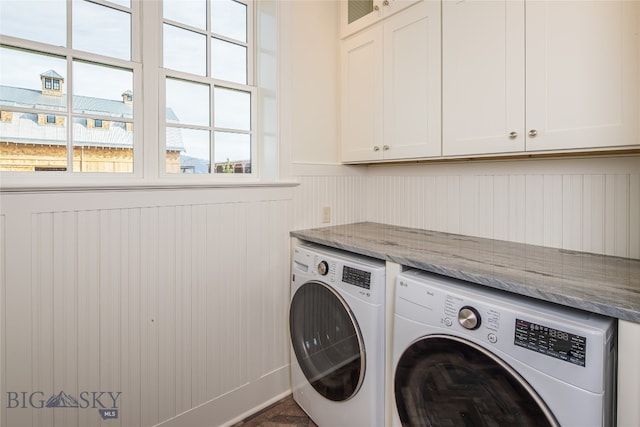 laundry area featuring washing machine and dryer and cabinets