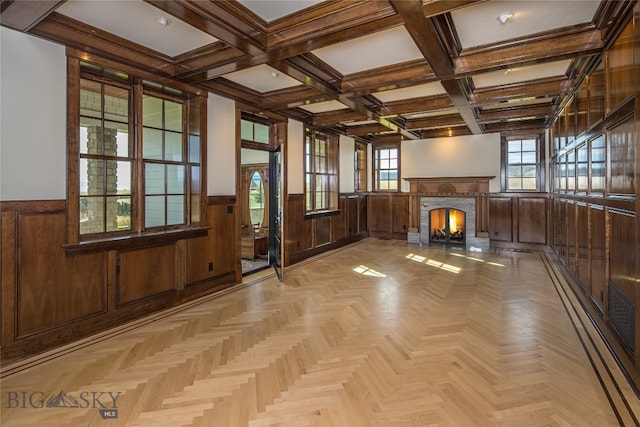 interior space with light parquet flooring, beam ceiling, and coffered ceiling