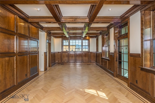 interior space featuring wood walls, beam ceiling, light parquet floors, and coffered ceiling