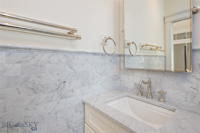 bathroom with tile walls and vanity