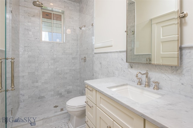 bathroom featuring tile walls, toilet, vanity, and a tile shower