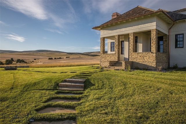 view of yard featuring a mountain view and a rural view