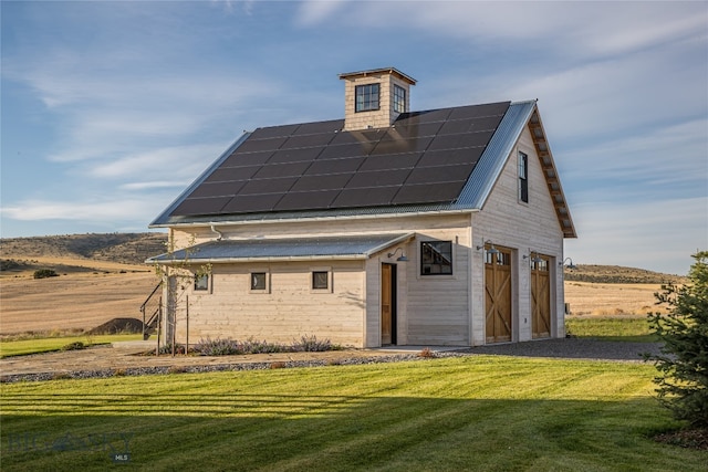 exterior space with solar panels and a yard