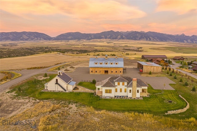 aerial view at dusk featuring a mountain view