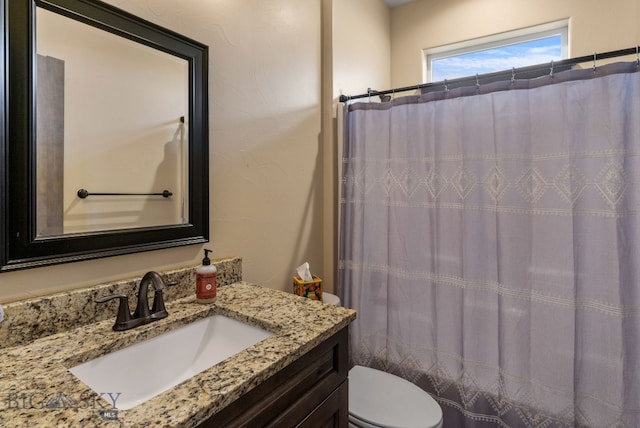 bathroom with vanity and toilet