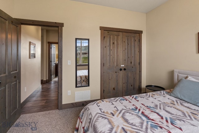 bedroom featuring dark hardwood / wood-style flooring and a closet