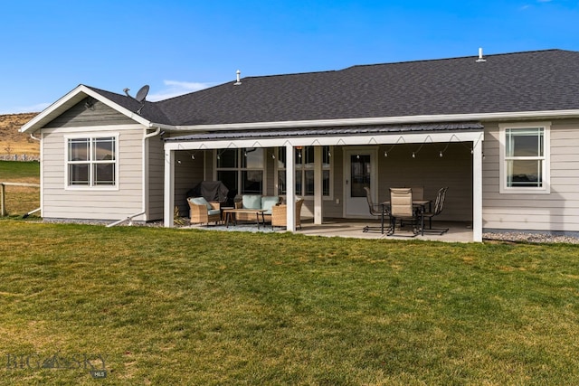 rear view of property featuring a yard and a patio