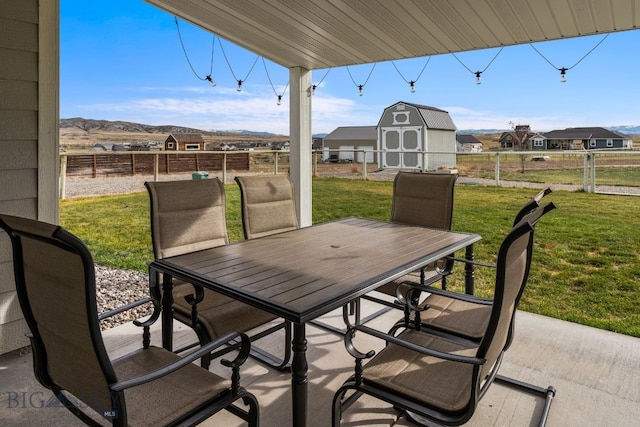 view of patio / terrace with a mountain view and a storage unit