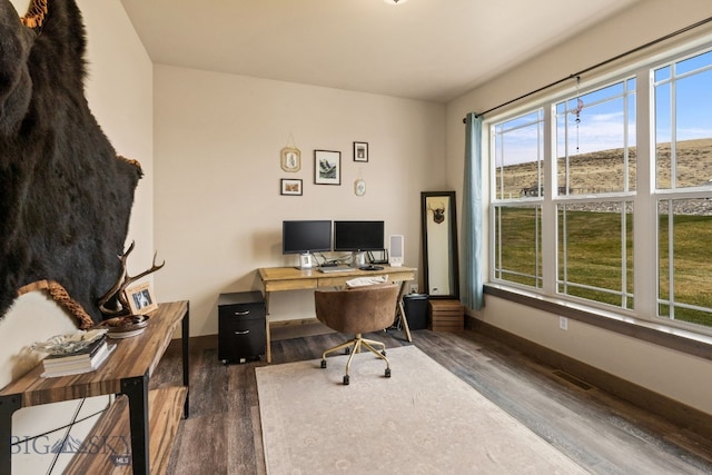 office space with dark wood-type flooring