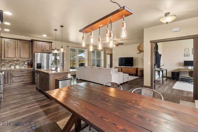 dining area featuring dark wood-type flooring