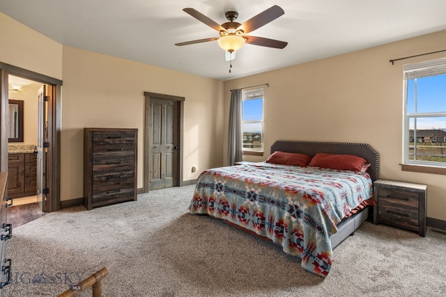 carpeted bedroom with connected bathroom and ceiling fan