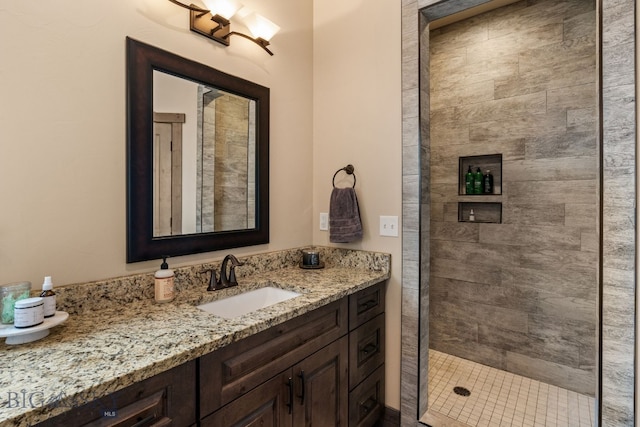 bathroom featuring vanity and tiled shower