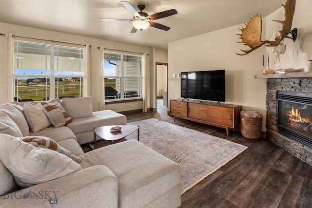 living room with a fireplace, dark hardwood / wood-style floors, and ceiling fan