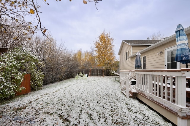 snowy yard with a deck