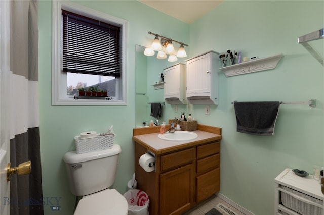 bathroom with toilet, vanity, and walk in shower