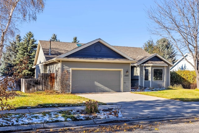 view of front of house with a garage and a front lawn