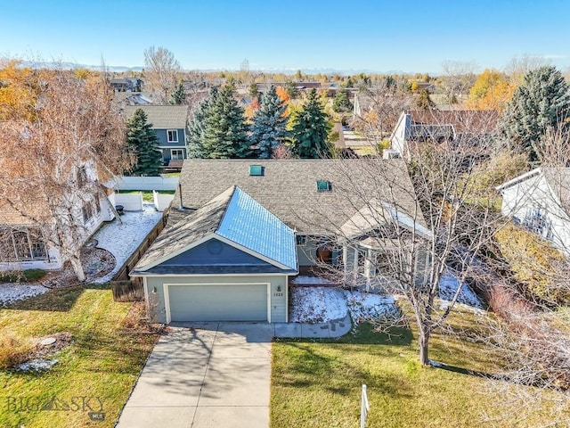 view of front of property featuring a garage and a front lawn