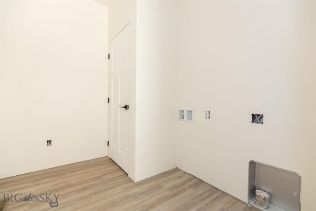 clothes washing area with light hardwood / wood-style flooring and washer hookup