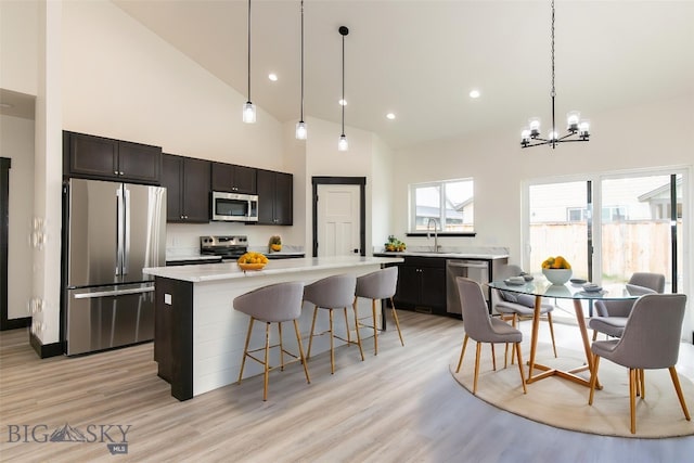1511 Pistolero Way, Belgrade, MT 59714 - kitchen featuring appliances with stainless steel finishes, a sink, a chandelier, light countertops, and light wood finished floors